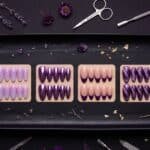 Six best purple nails styles including cat eye, ombre, chrome, french tip, dark and light purple nail designs flat lay on dark background